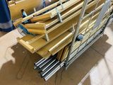 several pieces of wood are stacked on a cart in a warehouse
