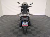 a motorcycle that is parked in a room with a checkered floor