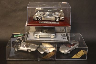 three cars in a display case on a black background