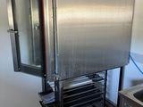 a large stainless steel refrigerator in the corner of a kitchen