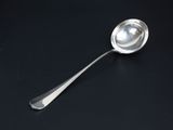 a close up of a spoon on a table with a black background