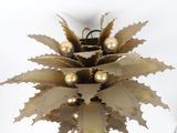 a gold christmas ornament hanging from the ceiling