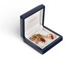 an open box with two rings in it on a white surface