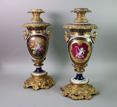 pair of antique vases with gold and blue decoration on them