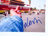 a picture of a hand holding a picture of a building