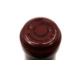 a close up of a bottle of wine on a white surface