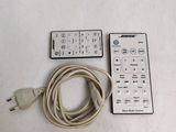 a remote control and a cable connected to a tv