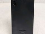 a close up of the back of a black samsung phone