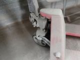 a fork lifter with a sign on it in a garage