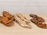 three pairs of women ' s shoes are lined up on a table
