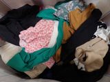 a pile of clothes that is sitting on a couch