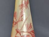 a red and yellow vase sitting on a table