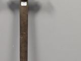 a close up of a knife with a gold handle on a white surface