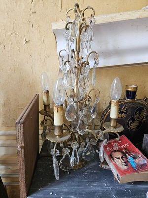 a table with a book and a chandelier on it