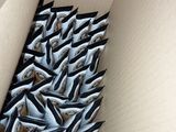 a cardboard box with a bunch of scissors in it
