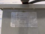a label on the back of a machine that is sitting on a table