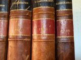 five books that are lined up on a shelf