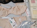 several bras and underwear are on a table with tags on them