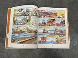 a picture of a comic book open on a table