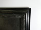 a picture of a black picture frame hanging on a wall