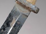 a close up of a knife with a wooden handle