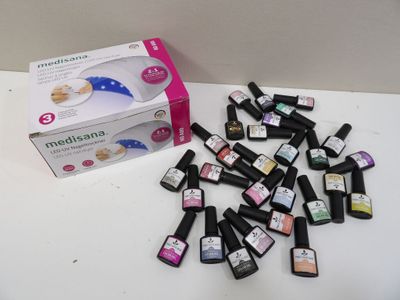 bottles of nail polish sitting on a table next to a box of nail polish