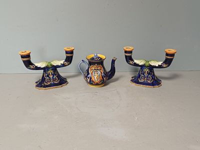 three blue and yellow vases sitting on a table