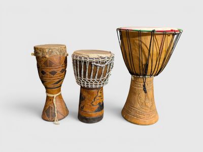 three different types of african drums on a white background