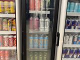 many cans of soda and soft drinks in the refrigerator