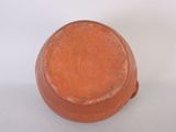 a small clay pot sitting on a white surface