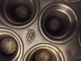 a metal pan filled with muffins and other food items