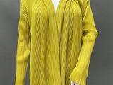an image of a mannequin wearing a yellow sweater and black pants