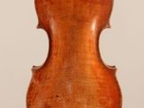 an old violin on a stand with a white background