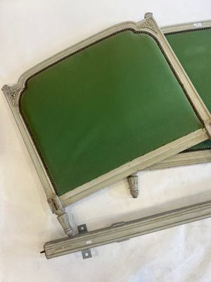 two green trays sitting on top of a white sheet