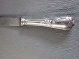 a silver knife that is sitting on a table