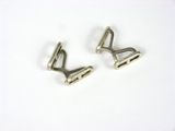 two pairs of silver metal clips on a white surface