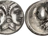 a silver coin with a woman and a man on it