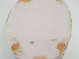 a white plate with a yellow and brown design on it