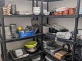 a kitchen with a lot of dishes on the shelves