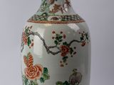 a white vase with flowers and birds on it
