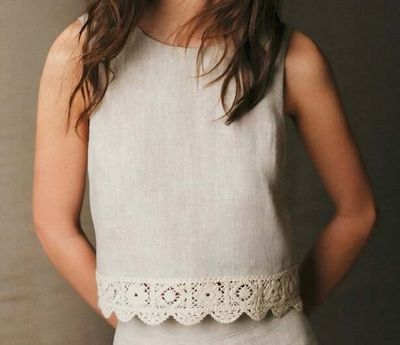 a woman that is wearing a white dress and a hat