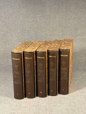 six books in a row on a gray surface