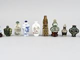 a lot of small vases sitting next to each other