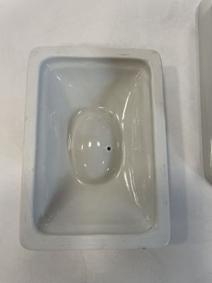 a white bowl and a white bowl sitting on a table