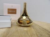 an image of a perfume bottle sitting on top of a wooden table next to a box