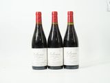 trois bouteilles de vin posées sur une table blanche