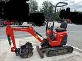 an image of a small excavator parked on the side of the road