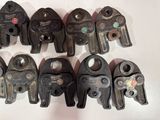 many different types of clamps on a white surface