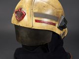 fireman ' s helmet on display against a black background