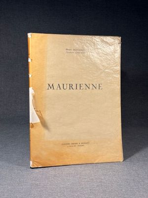 an old book sitting on top of a table next to a black background